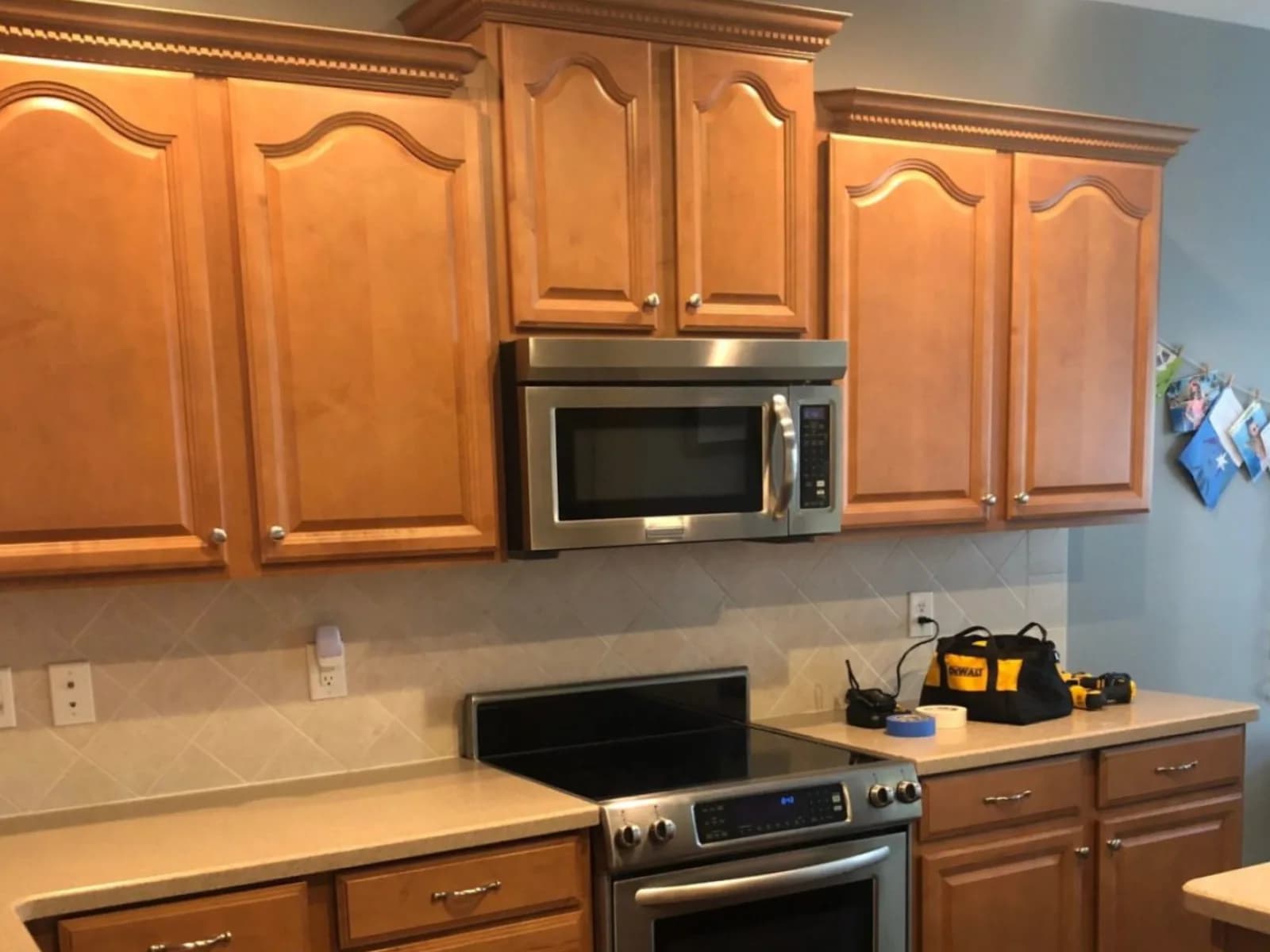 Before: Arched oak cabinets painted white